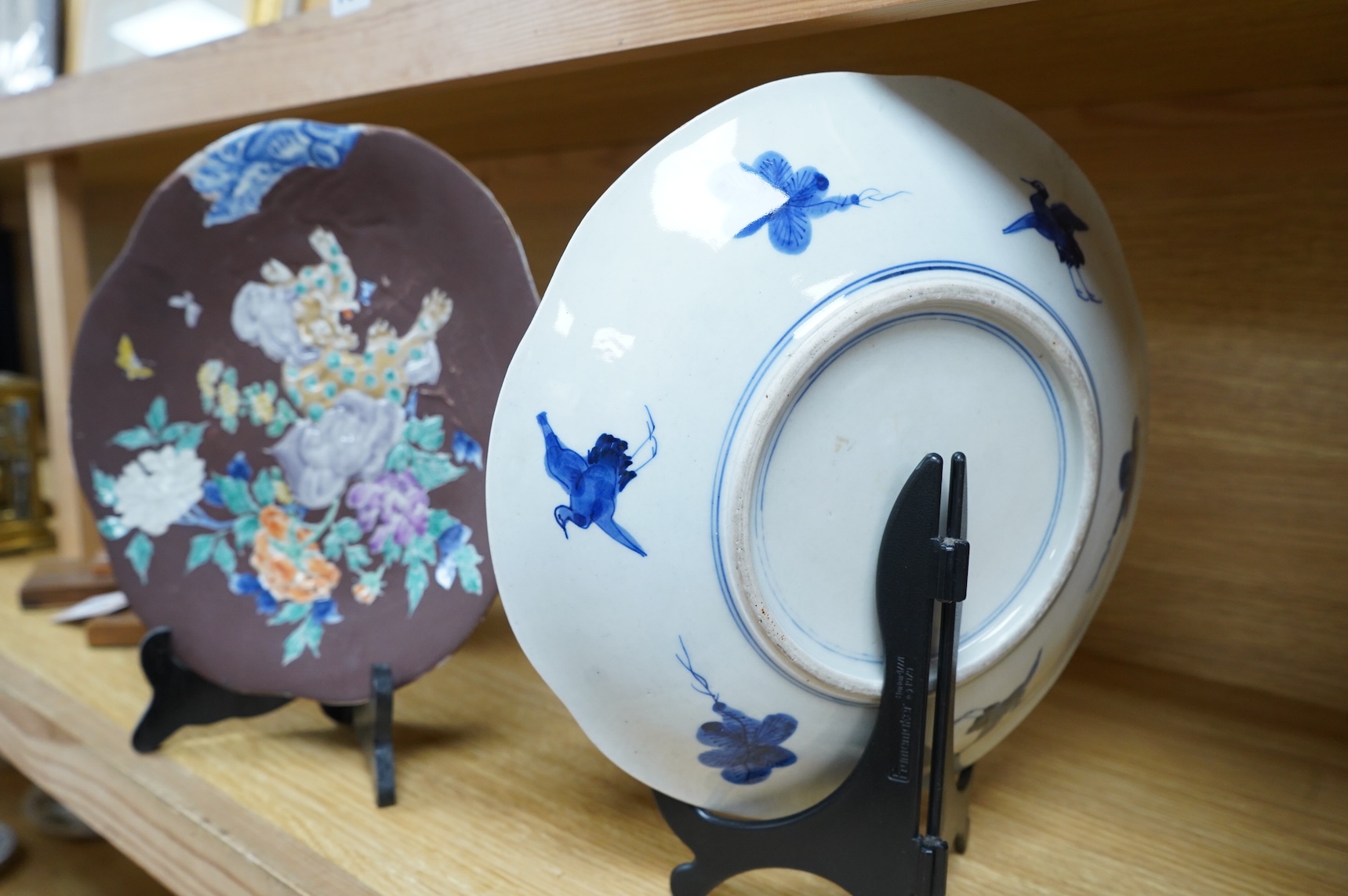 A pair of Japanese relief plates with brown glaze, 28cm high